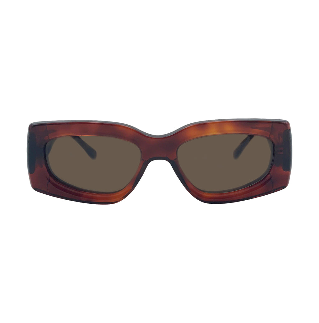 Oversized square sunglasses with a translucent tortoiseshell frame in brown and amber tones, featuring dark brown tinted lenses.