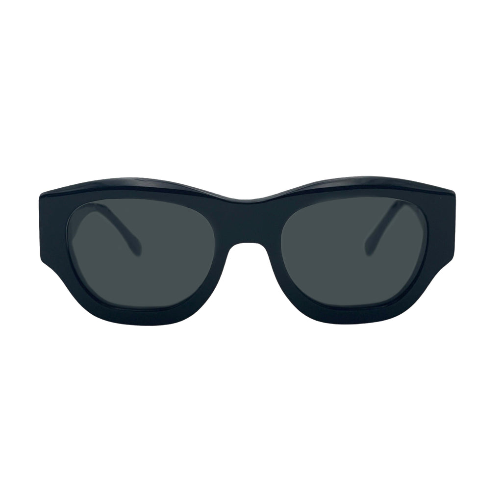 A pair of chunky, oversized square sunglasses with a matte black frame and dark gray lenses, shown from a front-facing perspective on a solid white background.