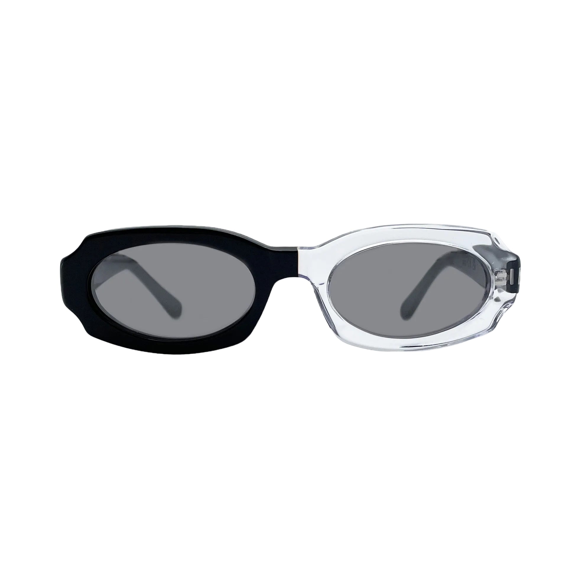 Oversized oval sunglasses with a black acetate front and temple arm, and a clear transparent acetate front, set against a light gray background.